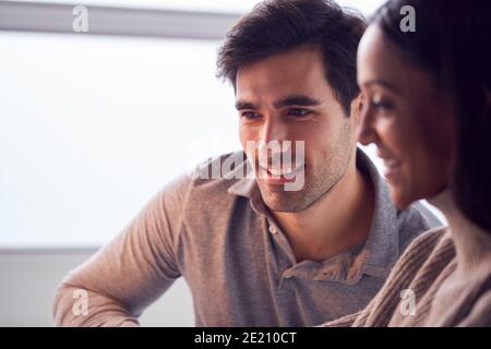 Close Up Of Businesswoman Working On Laptop At Desk Collaborating With Male Colleague Stock Photo