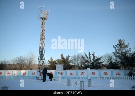 Dahinggan. 10th Jan, 2021. Staff members of local meteorological bureau maintain the facilities at an observatory in Huzhong District at the northern foot of the Dahinggan Mountains in northeast China's Heilongjiang Province, Jan. 10, 2021. Huzhong District is known as 'China's coldest town,' and the lowest temperature in the district dropped below minus 40 degrees Celsius in recent days. Credit: Wang Jianwei/Xinhua/Alamy Live News Stock Photo