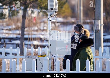 Dahinggan. 10th Jan, 2021. Staff members of local meteorological bureau maintain the facilities at an observatory in Huzhong District at the northern foot of the Dahinggan Mountains in northeast China's Heilongjiang Province, Jan. 10, 2021. Huzhong District is known as 'China's coldest town,' and the lowest temperature in the district dropped below minus 40 degrees Celsius in recent days. Credit: Wang Jianwei/Xinhua/Alamy Live News Stock Photo