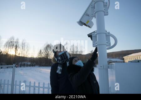 Dahinggan. 10th Jan, 2021. Staff members of local meteorological bureau maintain the facilities at an observatory in Huzhong District at the northern foot of the Dahinggan Mountains in northeast China's Heilongjiang Province, Jan. 10, 2021. Huzhong District is known as 'China's coldest town,' and the lowest temperature in the district dropped below minus 40 degrees Celsius in recent days. Credit: Wang Jianwei/Xinhua/Alamy Live News Stock Photo