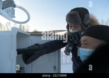 Dahinggan. 10th Jan, 2021. Staff members of local meteorological bureau maintain the facilities at an observatory in Huzhong District at the northern foot of the Dahinggan Mountains in northeast China's Heilongjiang Province, Jan. 10, 2021. Huzhong District is known as 'China's coldest town,' and the lowest temperature in the district dropped below minus 40 degrees Celsius in recent days. Credit: Wang Jianwei/Xinhua/Alamy Live News Stock Photo