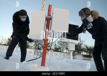 Dahinggan. 10th Jan, 2021. Staff members of local meteorological bureau maintain the facilities at an observatory in Huzhong District at the northern foot of the Dahinggan Mountains in northeast China's Heilongjiang Province, Jan. 10, 2021. Huzhong District is known as 'China's coldest town,' and the lowest temperature in the district dropped below minus 40 degrees Celsius in recent days. Credit: Wang Jianwei/Xinhua/Alamy Live News Stock Photo