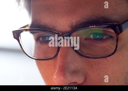 Close Up Of Businessman Wearing Glasses Looking At Computer Screen Stock Photo