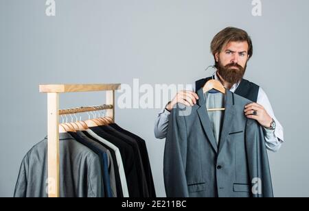 Shopper hipster man in fitting room menswear store, try on a suit concept. Stock Photo