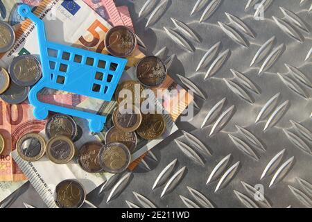 a small blue shopping cart on a checker plate Stock Photo