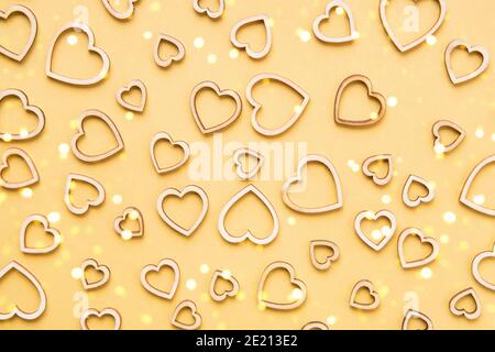 Valentines Day celebration concept. Wooden hearts on yellow background. Flat lay Stock Photo