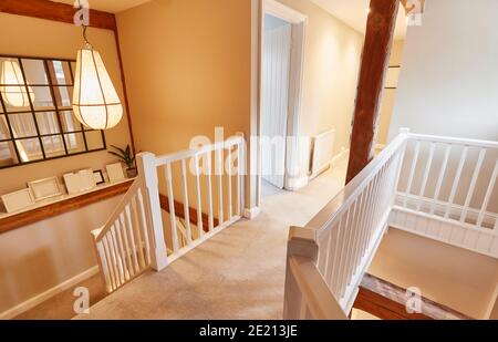 Interior View Of Beautiful Stairs And Landing With Exposed Wooden Beams In Family House Stock Photo