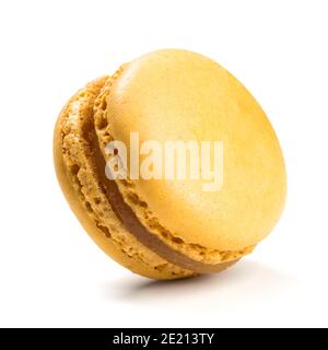 Lemon flavor macaron isolated on white background. Closeup of traditional French almond pastry. Stock Photo