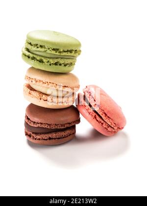 Stacked macarons of raspberry, vanilla, chocolate and pistachio flavors isolated on white background Stock Photo