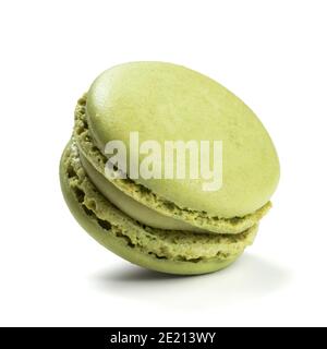 Pistachio flavor macaron isolated on white background. Closeup of traditional French almond pastry. Stock Photo
