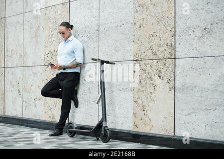 Stylish businessman texting colleagues Stock Photo