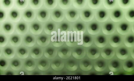 Blurred yellow metal background with black holes Stock Photo