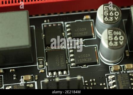 Transistors, chips and other elements on the motherboard electric circuit close-up. Stock Photo