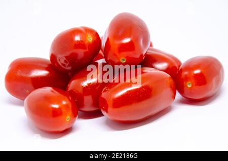 A pile of baby plumb tomatoes isolated on a white background. Stock Photo