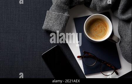 Flat Lay Lifestyle Shot With Jumper Notebook And Mobile Phone On Black Background Stock Photo