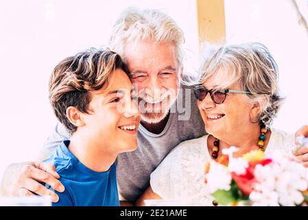 Cheerful family mixed ages and generations together have fun and smile - happy people grandfathers and grandson teenager together - senior man and wom Stock Photo