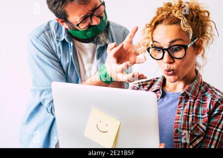 Funny image with wow expression beautiful woman using laptop computer and bound husband man trying to stop her - shopping on line activity with nice c Stock Photo