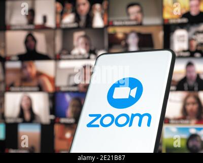 11 January 202 - Bucharest, Romania: Smartphone starting Zoom Cloud Meetings app with meeting on a background monitor Stock Photo
