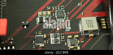 Transistors, chips and power components on motherboard of computer macro photo. Technology concept. Stock Photo