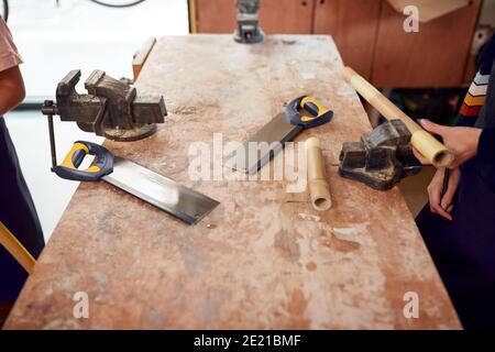 Close Up Of Tools On Workbench In Workshop Assembling Hand Built Sustainable Bamboo Bicycle Frames Stock Photo