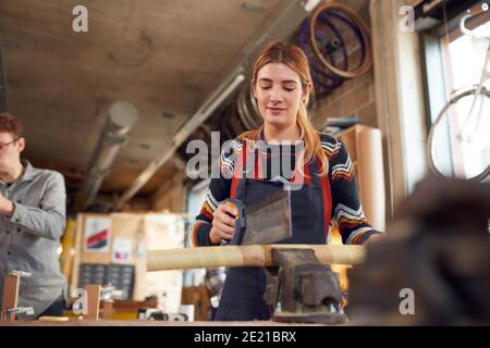 Multi-Cultural Team In Workshop Assembling Hand Built Sustainable Bamboo Bicycle Frame Stock Photo
