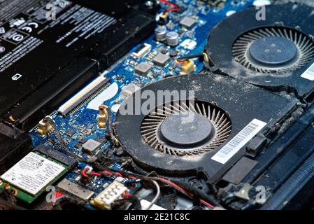 Dusty fan inside the laptop during servicing Stock Photo
