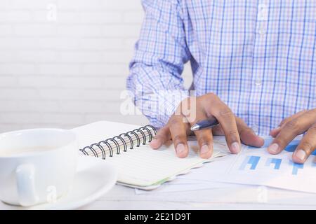 young man analyzing financial data on office desk with copy space  Stock Photo