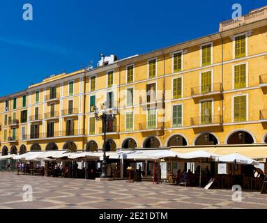 Brightly painted buildings with balconies and shuttered windows in Placa Major part or the Old Town area of Palma Mallorca Balearic Islands Spain Stock Photo