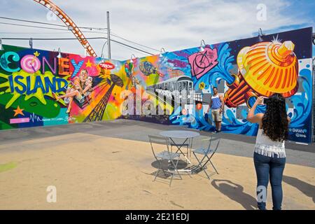 Tourists get their photo taken at one of the 30 or so CONEY ART WALLS in Coney Island, Brooklyn, New York City Stock Photo