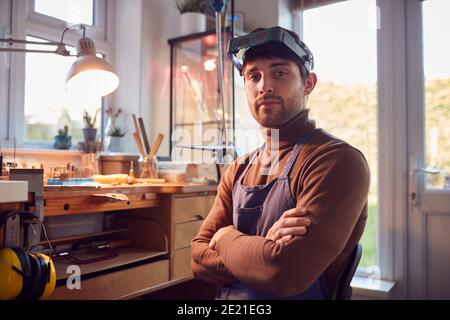 Portrait Of Male Jeweller Wearing Headband Magnifiers Working In Studio Stock Photo