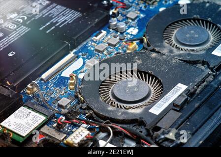 Dusty fan inside the laptop during servicing Stock Photo