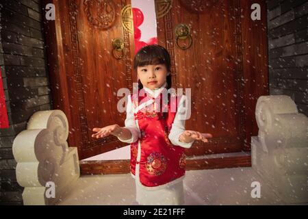 Beautiful little girl reached by snow Stock Photo