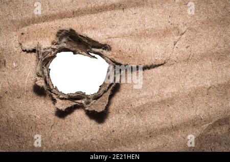 Closeup of paper hole with torn edges on white background, space for your text. Stock Photo