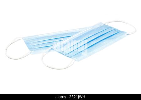 Two blue medical face masks isolated on white background. Surgical protective masks close-up. Stock Photo