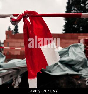 Knots in a red and white plastic abspector tape Stock Photo