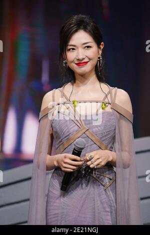 Chinese actress and singer Wan Qian, also known as Regina Wan, dressed in grey dress, sings during a promotional event in Shanghai, China, 10 January Stock Photo