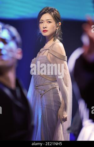 Chinese actress and singer Wan Qian, also known as Regina Wan, dressed in grey dress, sings during a promotional event in Shanghai, China, 10 January Stock Photo