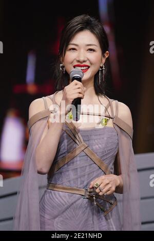 Chinese actress and singer Wan Qian, also known as Regina Wan, dressed in grey dress, sings during a promotional event in Shanghai, China, 10 January Stock Photo