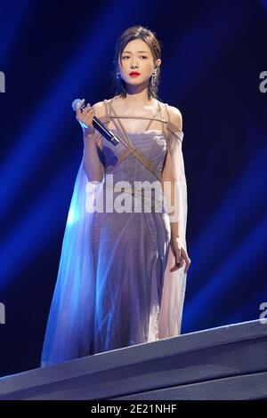 Chinese actress and singer Wan Qian, also known as Regina Wan, dressed in grey dress, sings during a promotional event in Shanghai, China, 10 January Stock Photo