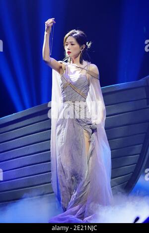 Chinese actress and singer Wan Qian, also known as Regina Wan, dressed in grey dress, sings during a promotional event in Shanghai, China, 10 January Stock Photo