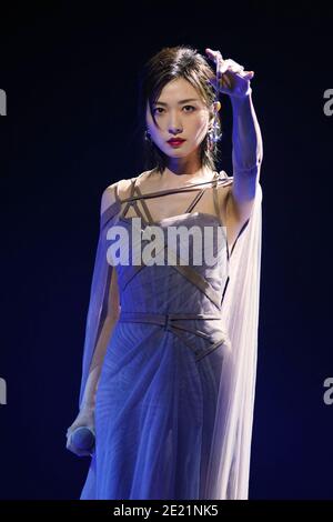 Chinese actress and singer Wan Qian, also known as Regina Wan, dressed in grey dress, sings during a promotional event in Shanghai, China, 10 January Stock Photo