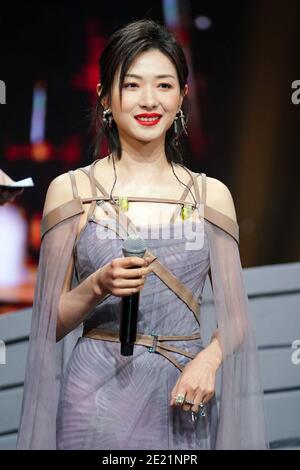 Chinese actress and singer Wan Qian, also known as Regina Wan, dressed in grey dress, sings during a promotional event in Shanghai, China, 10 January Stock Photo