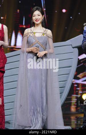 Chinese actress and singer Wan Qian, also known as Regina Wan, dressed in grey dress, sings during a promotional event in Shanghai, China, 10 January Stock Photo