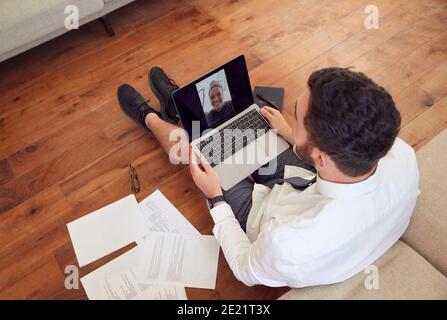 Businessman Wearing Loungewear And Shirt And Tie For Video Call On Laptop Working From Home Stock Photo