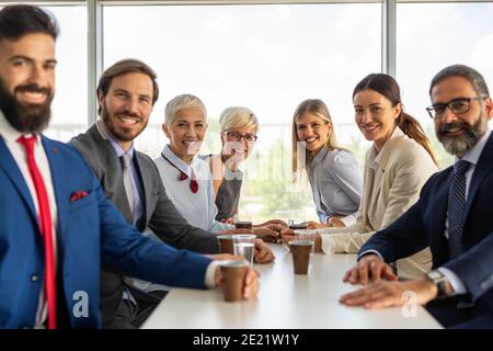 Portrait of successful business team posing in office Stock Photo