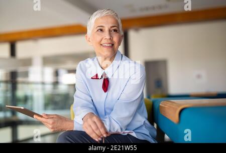 Portrait of a successful business woman using digital tablet in office Stock Photo