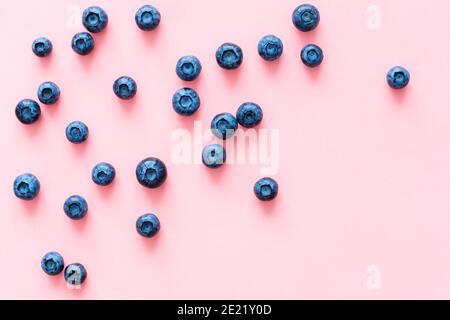 blueberries on pink background. Top view. Flat lay Stock Photo