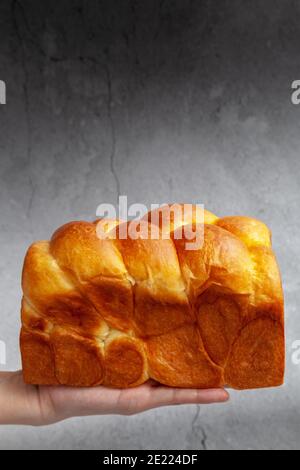 Brioche is a bread of French origin that is similar to a highly enriched pastry, and whose high egg and butter content gives it a rich and tender crum Stock Photo