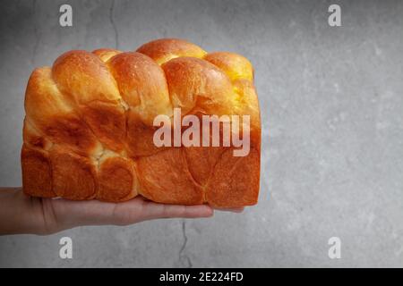 Brioche is a bread of French origin that is similar to a highly enriched pastry, and whose high egg and butter content gives it a rich and tender crum Stock Photo