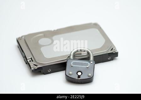 Computer hard disk and metal padlock symbolizing concept for encrypted data, cyber security Stock Photo